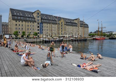 People Sunbathing In The Center Of Copenhagen On Denmark