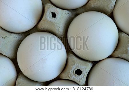 White Chicken Eggs Are Fresh, Stacked In Ecological Cardboard Packaging. Food Background. Top Viev. 