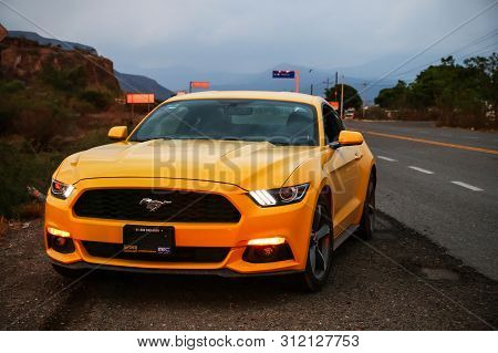 Oaxaca, Mexico - May 26, 2017: Yellow Supercar Ford Mustang At The Roadside Of The Interurban Road.