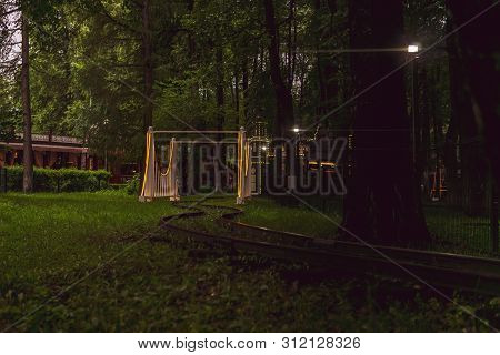 Perm, Russia - July 01, 2019: Rails And Arch Of The Narrow Gauge Railway In The Evening Amusement Pa