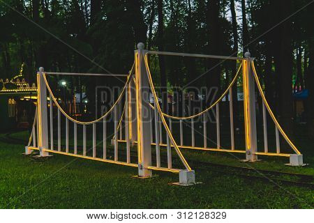 Perm, Russia - July 01, 2019: Rails And Arch Of The Narrow Gauge Railway In The Evening Amusement Pa