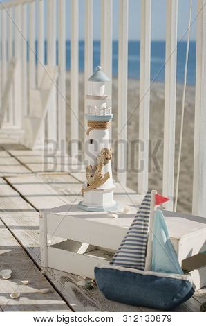 Omposition With Beach Decoration Shells, Boat And Lighthouse, With Pillowson Wave Ocean Background, 