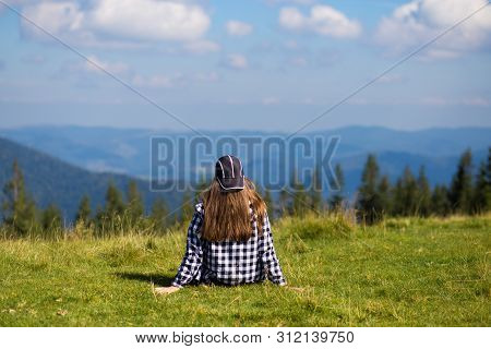 Successful Woman In Cap On Top Of Hill Enjoy View On Mountain Peak