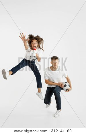 Portrait Of Beautiful Young Couple Football Or Soccer Fans On White Studio Background. Facial Expres