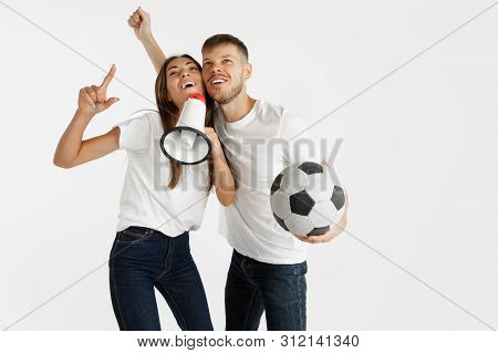Portrait Of Beautiful Young Couple Football Or Soccer Fans On White Studio Background. Facial Expres
