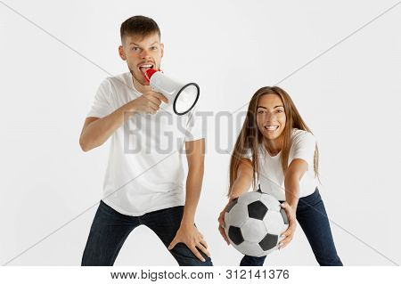 Portrait Of Beautiful Young Couple Football Or Soccer Fans On White Studio Background. Facial Expres