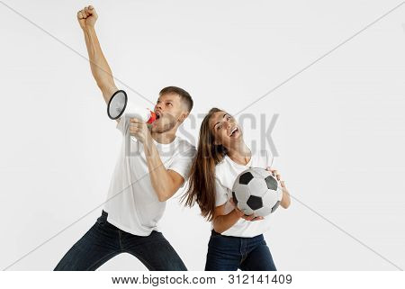 Portrait Of Beautiful Young Couple Football Or Soccer Fans On White Studio Background. Facial Expres