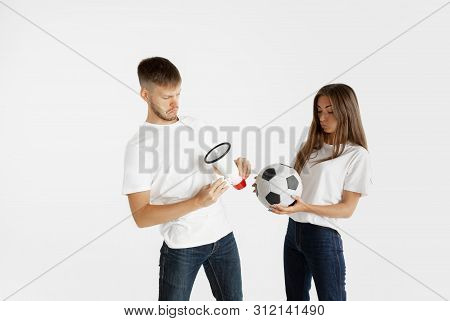 Portrait Of Beautiful Young Couple Football Or Soccer Fans On White Studio Background. Facial Expres