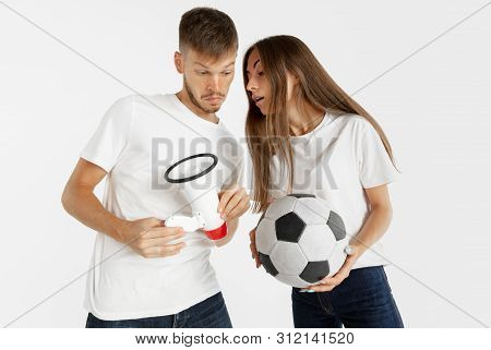Portrait Of Beautiful Young Couple Football Or Soccer Fans On White Studio Background. Facial Expres
