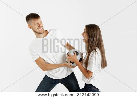Portrait Of Beautiful Young Couple Football Or Soccer Fans On White Studio Background. Facial Expres