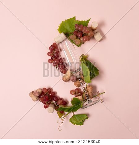Alphabet. Letter S Made Of Wineglasses With Rose And White Wine, Grapes, Leaves And Corks Lying On P
