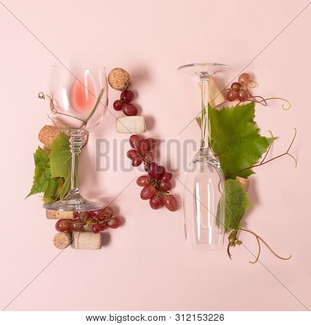 Alphabet. Letter N Made Of Wineglasses With Rose And White Wine, Grapes, Leaves And Corks Lying On P