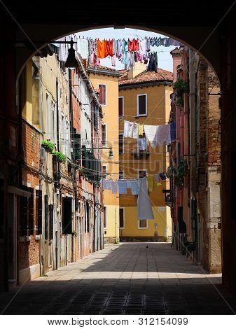 Buildings In Venice, Clotheslines Hanging Between Houses