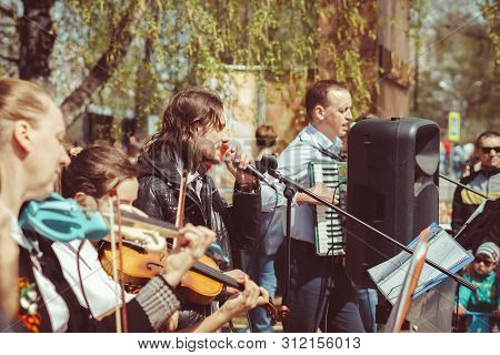 Russia, Siberia, Novokuznetsk - May 9, 2019: Musicians Sing Songs On The Street On Victory Day