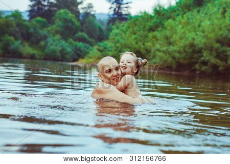 Happy Family Father And Son. Dad Teaches His Son To Swim