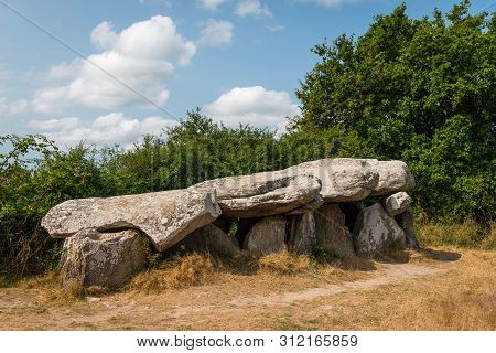 A Megalithic Tomb On A Sunny Day Standing Near Saint Lyphard (france)