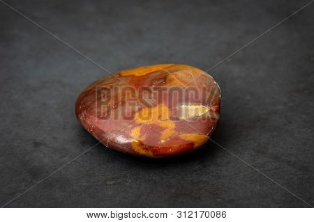 Red Gemstone With Colorful Structure In Many Tones Formed Under High Pressure Found In River