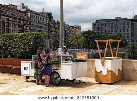 Bilbao, Spain, July 29, 2018: Ice Cream Vendors And Customers In The Downtown Area Of ​​bilbao Spain