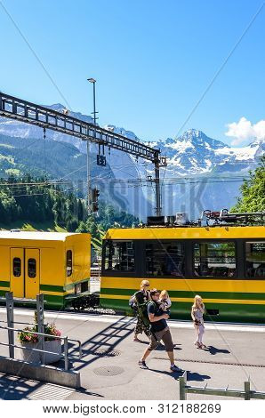 Wengen, Switzerland - July 16 2019: Family On Trip Walking On Platform In Main Train Statio. Beautif