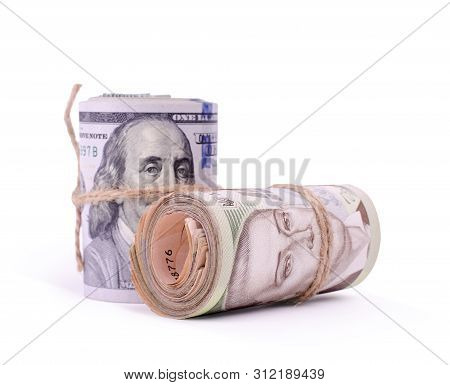 Tubes Of United States Dollars And Ukrainian Hryvnia Uah Banknotes Isolated On A White. Financial Bu