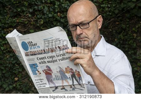 Udine, Italy. July 15, 2019.  The Lecture Of The  American Usa Today Newspaper On A Wooden Table.