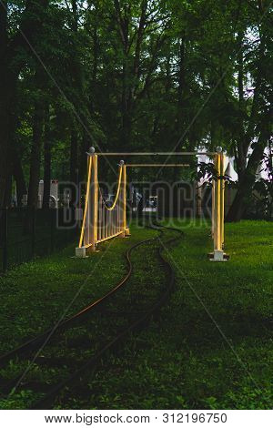 Rails And Arch Of The Narrow Gauge Railway In The Evening Amusement Park