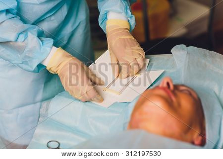Aged Woman Doing Mesothreads And Thread Lifting, Cosmetology. Cosmetic Procedure To Eliminate Signs 