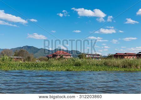 Horizontal Picture Of Local Vegetation And Huge Buildings, Located In Inle Lake, Landmark Of Myanmar