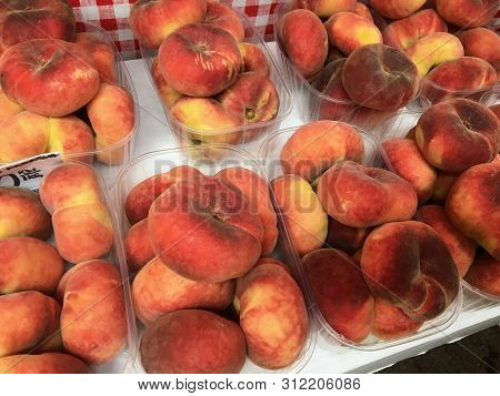 Boxes Of Saturn Peaches Sold At A Market In Croatia.  The Flat Peach (prunus Persica Var. Platycarpa