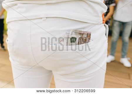 Bundle Of Banknotes Stick Out From The Back Pocket In White Jeans Of A Person On The Party