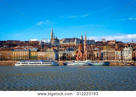 View Of The Buda From Pest. The Fisherman's Bastion, The Matthias Church And Protestant Church. Buda