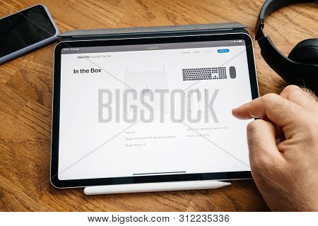 Paris, France - Jun 6, 2019: Man Reading On Apple Ipad Pro Tablet About Latest Announcement Of At De