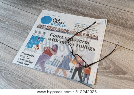 Udine, Italy. July 15, 2019.  The Lecture Of The  American Usa Today Newspaper On A Wooden Table.