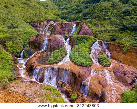 Aerial View Of Golden Waterfall. Nature Landscape Of Jinguashi In Ruifang Area. It Is Located In New