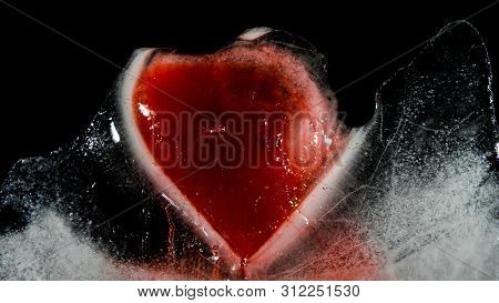 Red Heart In Ice Melting, Looks Like It Is Bleeding. Love - Leaving.