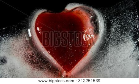 Red Heart In Ice Melting, Looks Like It Is Bleeding. Love - Leaving.