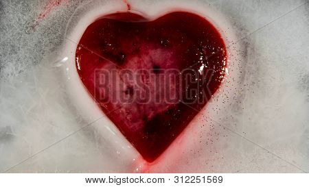 Red Heart In Ice Melting, Looks Like It Is Bleeding. Love - Leaving.