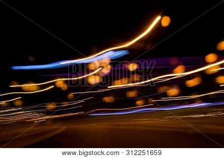 A View Through The Windshield While Driving At Night. Long Exposure. Artistic, Abstract.