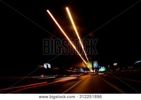 A View Through The Windshield While Driving At Night. Long Exposure. Artistic, Abstract.