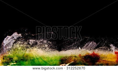 Multicolored Ice Plate Melting 04. Several Colors In Ice. Green And Blue Dominant.