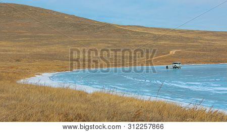 Siberia, Russia - February 17, 2019: Russian Military Jeeps That Use For Take Tourists Cross Frozen 