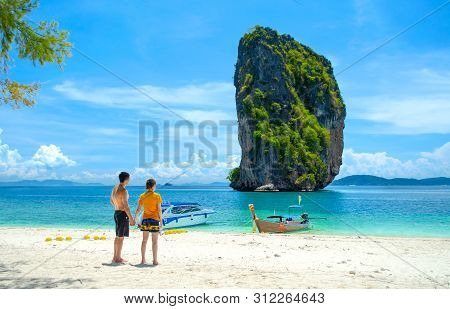 Couple On The Beach, Standing Holding Hands Looking At The Beautiful Sea View At Poda Island - Krabi