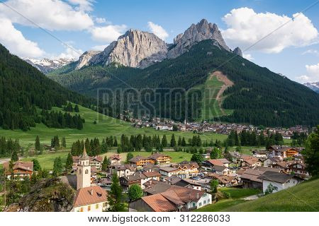 Beautiful Alpine Landscape. Village Pozza Di Fassa At The Foot Of Dolomites, Italy