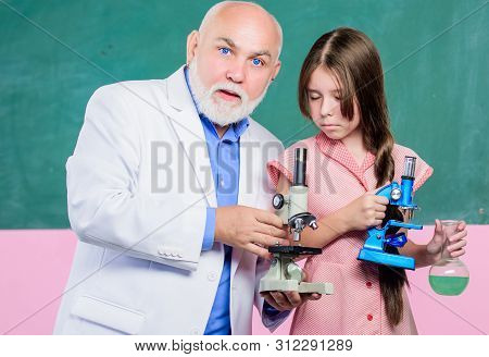 Chemical Industry. Mature Teacher Of Biology. Pupil Girl In School Lab. Small Girl With Man Tutor St