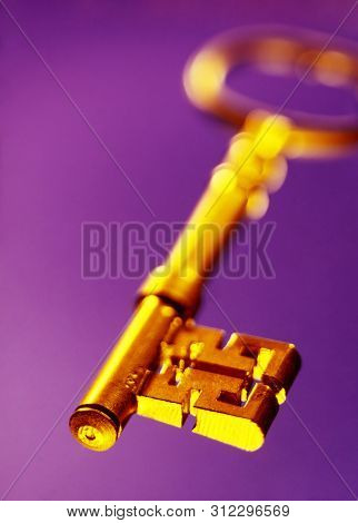 Old Fashioned Antique Golden Key Floaring On A Purple Background