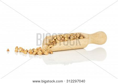 Lot Of Whole Hulled Raw Brown Buckwheat Grain With Wooden Scoop Isolated On White Background