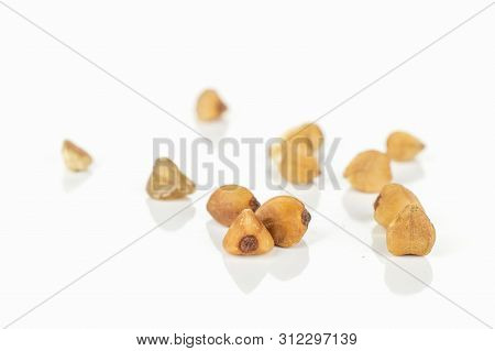 Lot Of Whole Hulled Raw Brown Buckwheat Grain Isolated On White Background