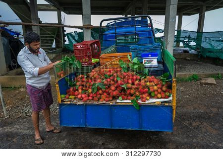 Vagamon, Kerala, India- 07 July 2019: Man Selling Rambutan On Road Side