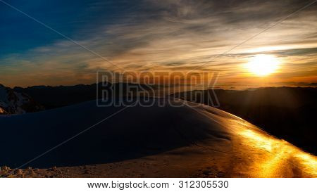 Landscape View To The East From The Mountain Hut Kredarica. Winter Sunrise In Julian Alps, Slovenia,