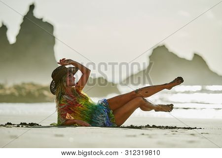 young woman relaxing on the beach in summer day